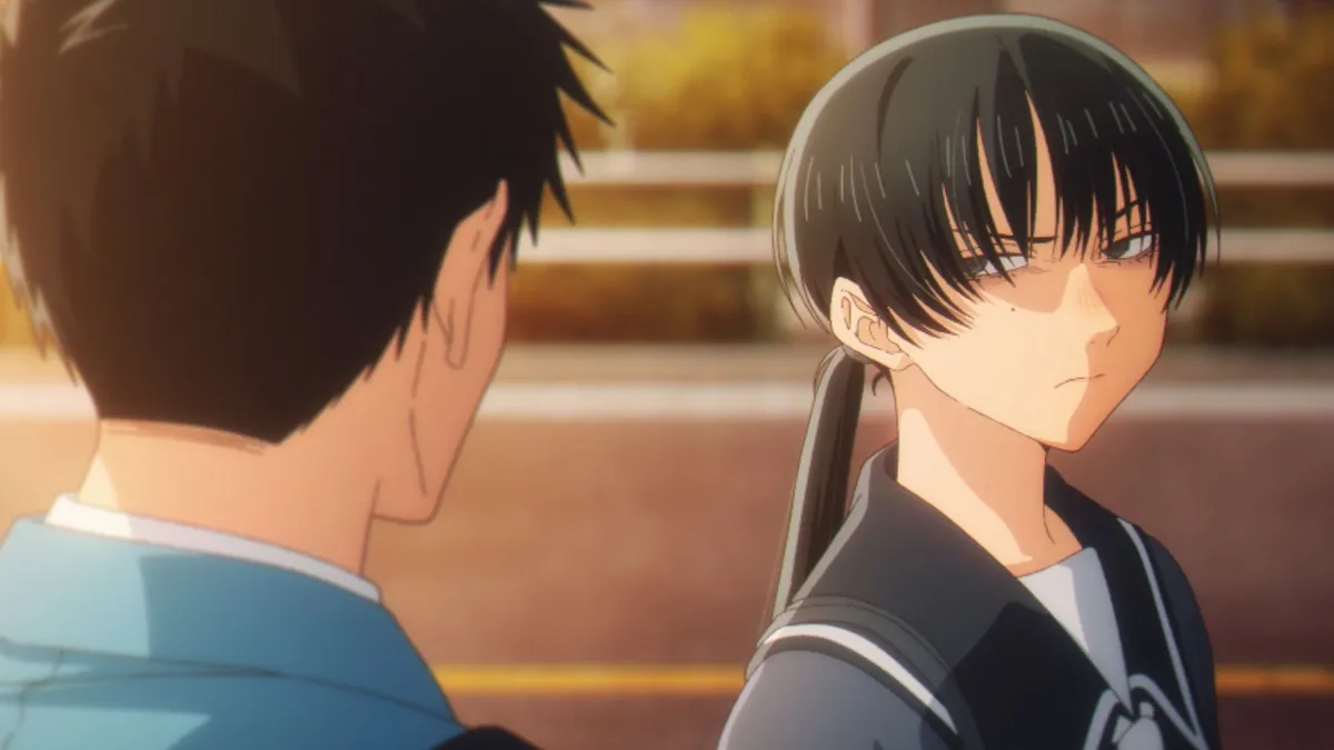 Yumeka, in a dark sailor uniform with her hair in a ponytail, glares back over her shoulder at a boy seen from behind at sunset, in a still from Blue Box season 2, episode 2